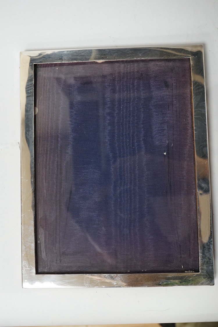 An Edwardian silver mounted photograph frame, King & Sons, Birmingham, 1907, 23.7cm, together with two later George V silver mounted photograph frames, Birmingham, 1917 and Birmingham, 1925. Condition - fair